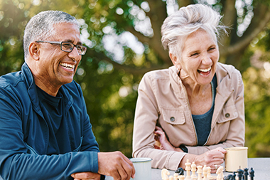 seniors playing chess outdoors retirement strategies greene financial michigan